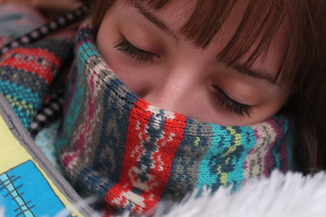 woman with a scarf covering her mouth